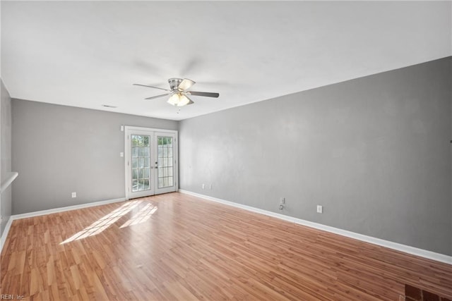 spare room with ceiling fan, french doors, and light hardwood / wood-style floors