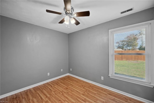 spare room featuring light wood-type flooring and ceiling fan