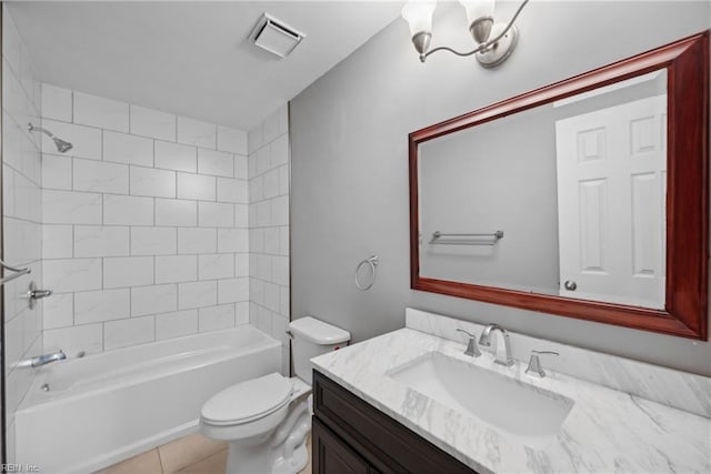 full bathroom featuring toilet, tiled shower / bath combo, vanity, and tile patterned floors