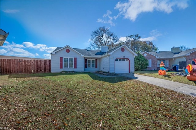 ranch-style home with a garage and a front yard