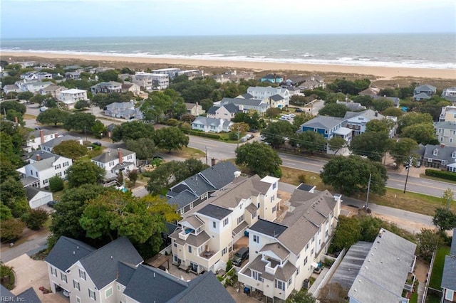 birds eye view of property with a water view and a view of the beach