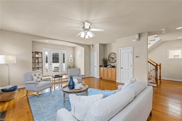 living room with wood-type flooring and ceiling fan