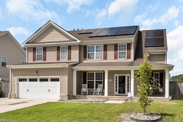 view of front of home featuring a garage, a porch, a front lawn, and solar panels