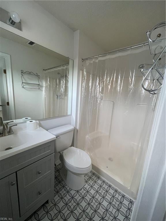 bathroom featuring vanity, toilet, and a shower with curtain