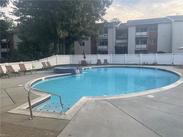 view of pool featuring a hot tub and a patio area