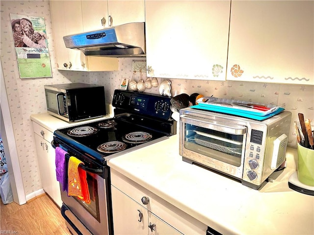 kitchen featuring stainless steel electric stove and light wood-type flooring