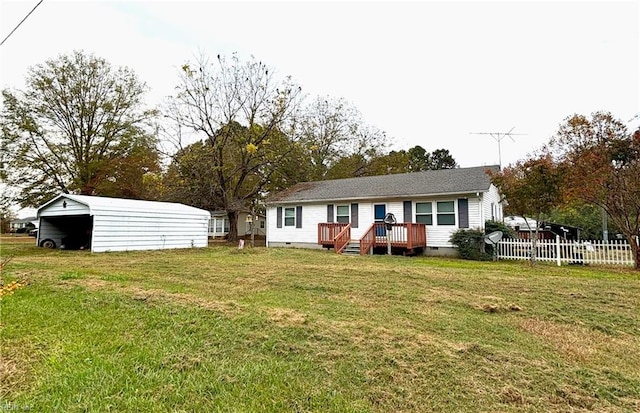 rear view of house with a lawn and a carport