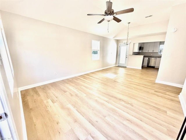 unfurnished living room featuring light hardwood / wood-style floors, ceiling fan with notable chandelier, and vaulted ceiling