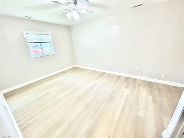 spare room featuring ceiling fan and light hardwood / wood-style flooring