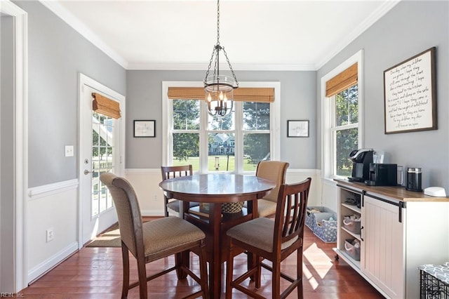 dining area with a notable chandelier, crown molding, baseboards, and dark wood-type flooring