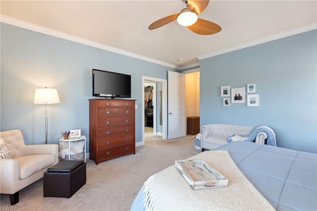 bedroom with light carpet, a ceiling fan, a closet, a walk in closet, and crown molding