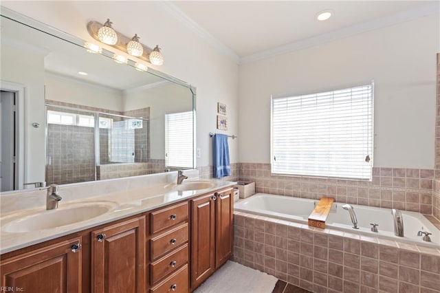 full bath featuring ornamental molding, plenty of natural light, and a sink