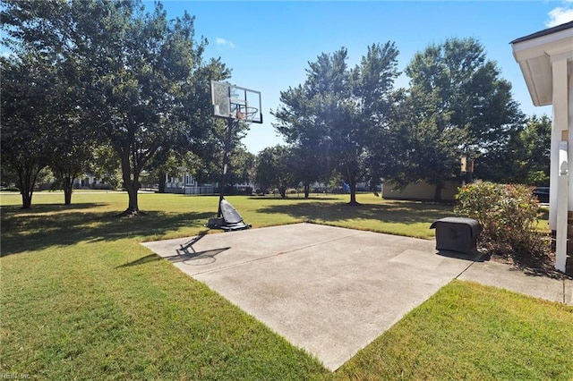 view of sport court with basketball court and a lawn