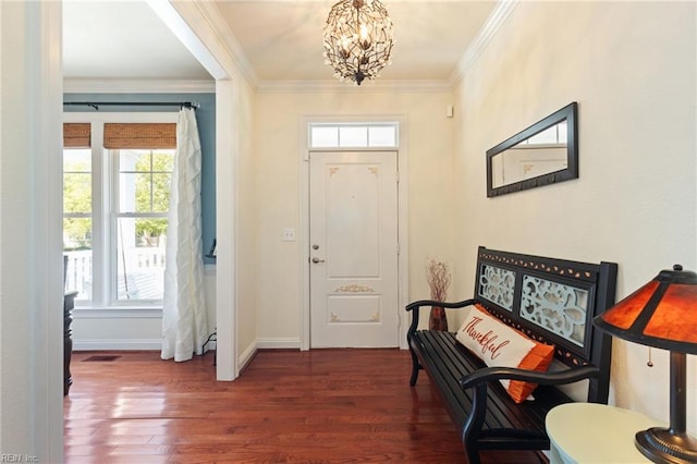 foyer featuring ornamental molding, a notable chandelier, baseboards, and dark wood-style floors