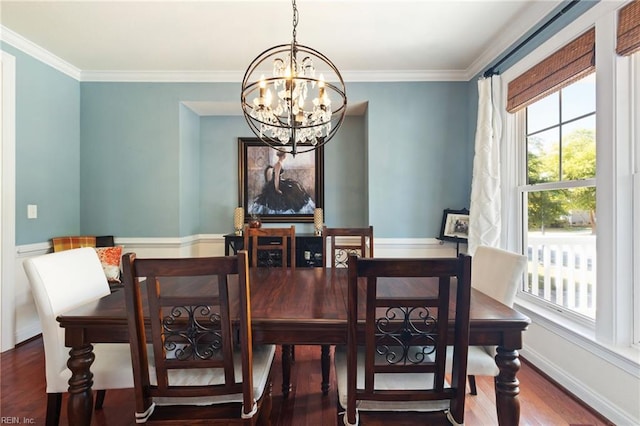 dining area featuring baseboards, a chandelier, wood finished floors, and ornamental molding