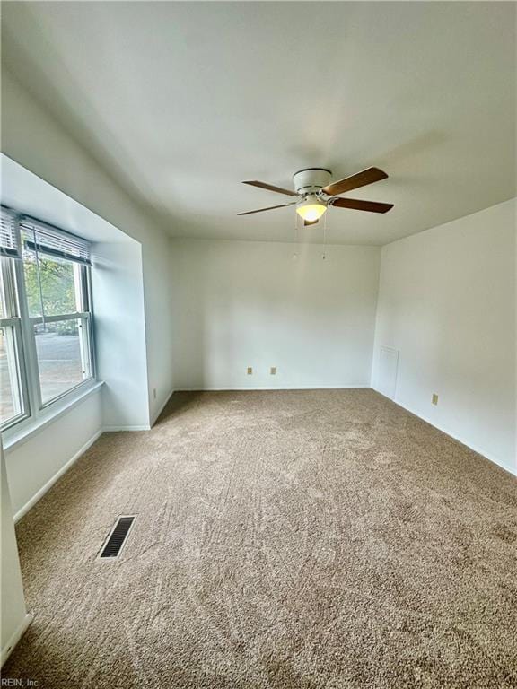 carpeted empty room with ceiling fan