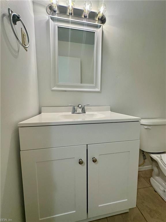 bathroom with vanity, tile patterned flooring, and toilet