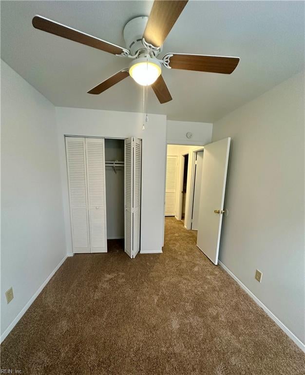 unfurnished bedroom featuring ceiling fan, a closet, and carpet floors