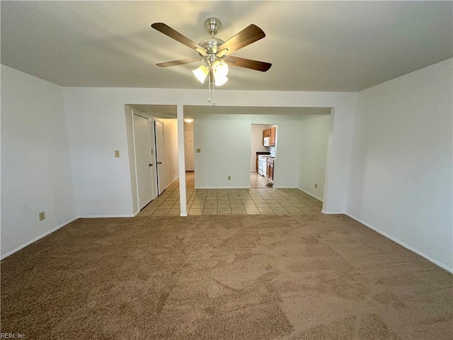 unfurnished room with light colored carpet and ceiling fan