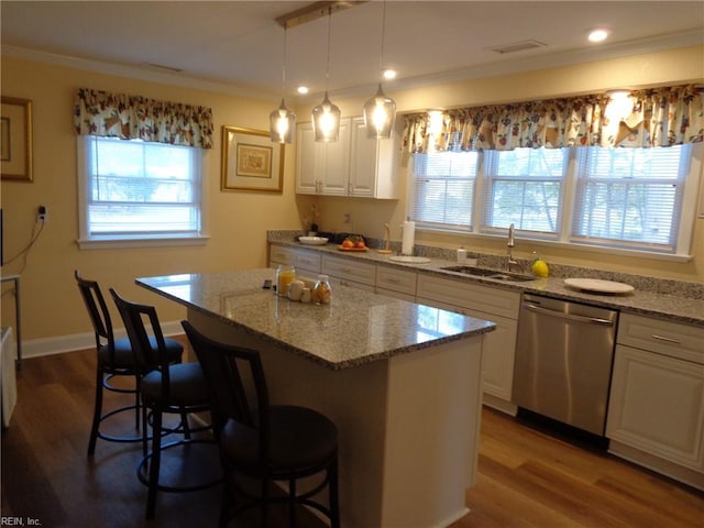 kitchen featuring a center island, dishwasher, hardwood / wood-style floors, sink, and white cabinetry