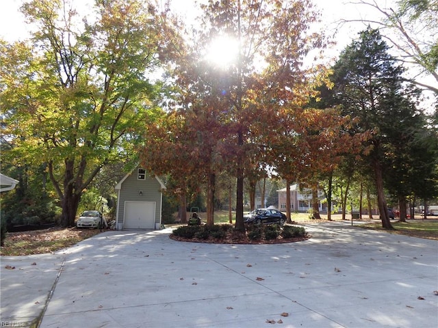 view of property hidden behind natural elements with a garage