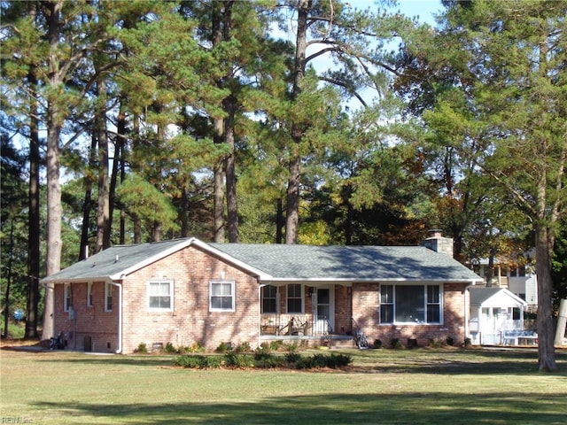 view of front facade with covered porch and a front yard