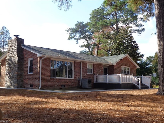 rear view of house with central air condition unit and a deck