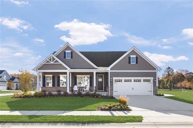 craftsman inspired home with a garage, a front lawn, and covered porch