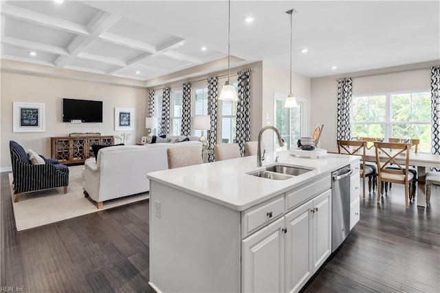 kitchen featuring a center island with sink, white cabinets, sink, dark hardwood / wood-style floors, and decorative light fixtures