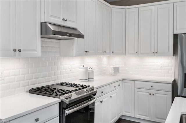 kitchen featuring white cabinetry, stainless steel appliances, and tasteful backsplash