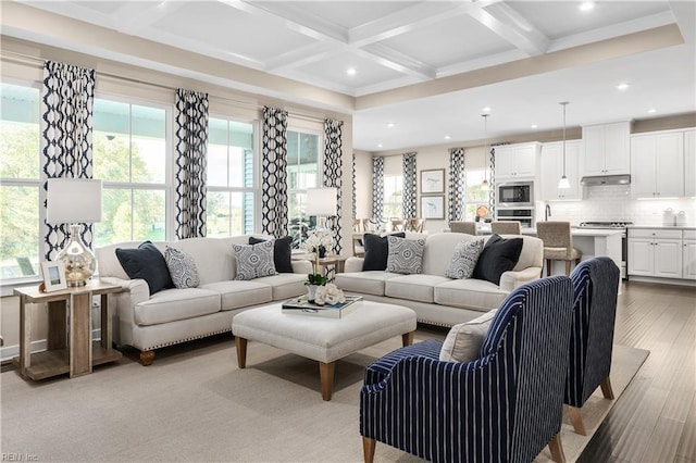 living room featuring a wealth of natural light, beamed ceiling, light wood-type flooring, and coffered ceiling