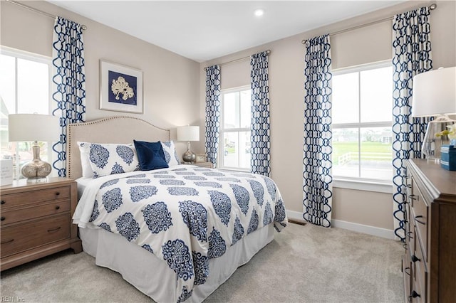 bedroom featuring light colored carpet