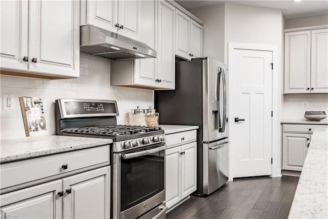 kitchen featuring white cabinetry, appliances with stainless steel finishes, dark wood-type flooring, and light stone countertops