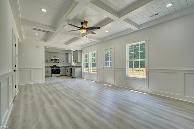 unfurnished living room with light wood-type flooring, coffered ceiling, ceiling fan, and beamed ceiling