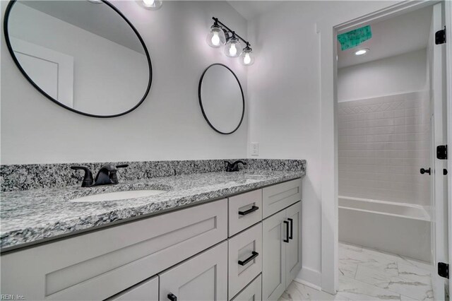 bathroom with vanity and shower / washtub combination