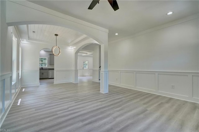 spare room with ornamental molding, light hardwood / wood-style flooring, and ceiling fan