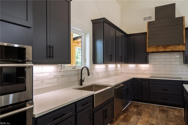 kitchen with stainless steel appliances, sink, backsplash, and dark hardwood / wood-style flooring