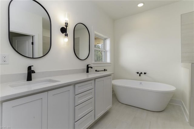 bathroom featuring a bath and vanity