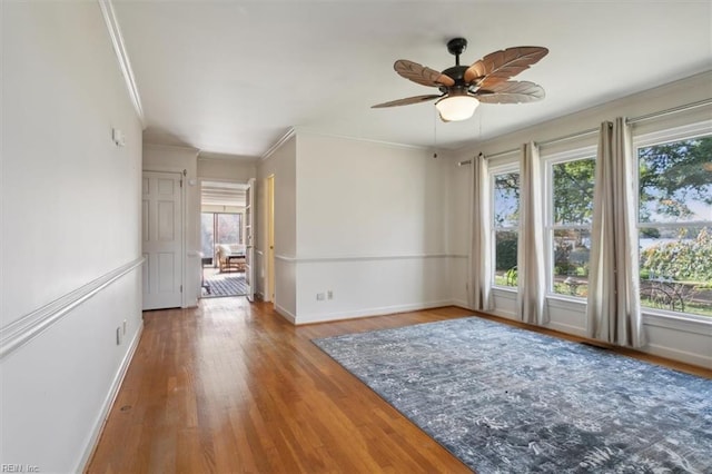 unfurnished room with ceiling fan, wood-type flooring, and ornamental molding