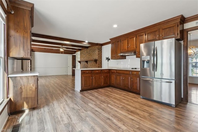 kitchen featuring black electric cooktop, stainless steel refrigerator with ice dispenser, beam ceiling, and light hardwood / wood-style floors