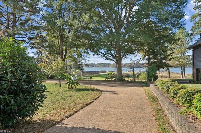 surrounding community featuring a water view and a yard