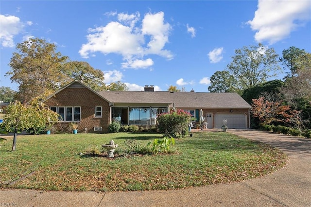 ranch-style home featuring a garage and a front yard