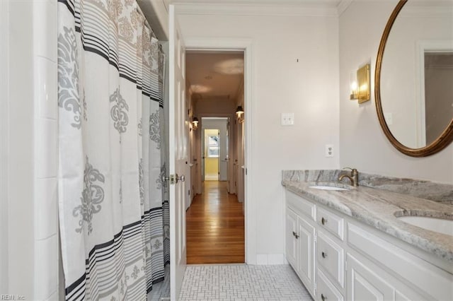 bathroom with wood-type flooring, vanity, and ornamental molding