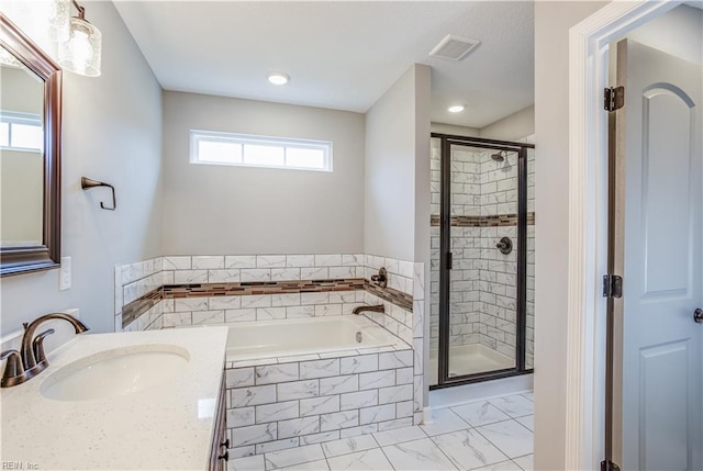 bathroom with vanity, a wealth of natural light, and plus walk in shower