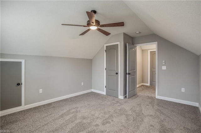 additional living space featuring vaulted ceiling, ceiling fan, and light colored carpet