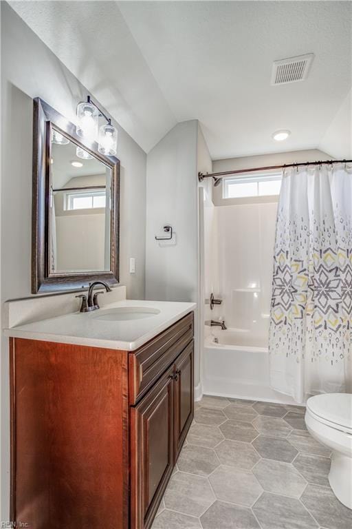 full bathroom with shower / bathtub combination with curtain, tile patterned floors, vaulted ceiling, vanity, and toilet