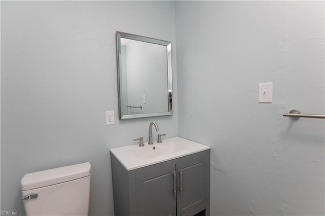 bathroom with toilet and vanity