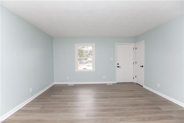 unfurnished room with light hardwood / wood-style floors