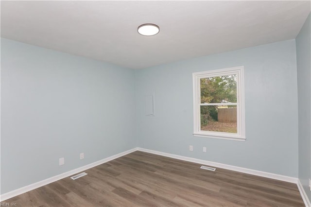 unfurnished room with dark hardwood / wood-style floors