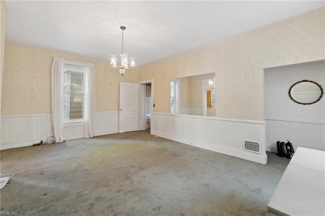 unfurnished dining area with a chandelier and carpet